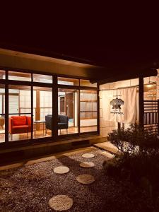 a living room with a couch and a chair at IPPONMATSU Private Villa - 宮崎の古民家一棟貸し 一本松 in Miyazaki