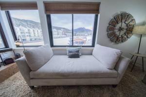 a couch in a living room with a large window at Edgewater 1436 by SummitCove Lodging in Colorado in Keystone