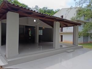 an image of a house with a patio at Hotel Sancer in Coronel Oviedo