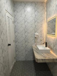 a white bathroom with a sink and a mirror at นนท์ ณ in Ban Non Makhuk +96 photos