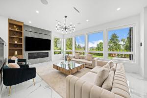 a living room with a couch and a tv at North Shore Luxe Villa in North Vancouver +20 photos