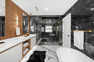 a bathroom with a black and white marble floor at North Shore Luxe Villa in North Vancouver