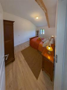 a bedroom with a bed and a wooden table at Maison de campagne T3 Nature in La Martre