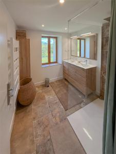 a bathroom with a sink and a mirror at Maison de campagne T3 Nature in La Martre