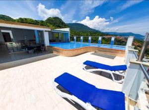 a villa with a swimming pool and a patio at Apartamentos Quedate en Anavi San Gil Plaza in San Gil