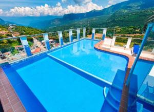 a swimming pool with a view of a mountain at Apartamentos Quedate en Anavi San Gil Plaza in San Gil