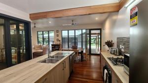 a kitchen with a sink and a stove at Rainforest Escape moments from Waterfall in Kuranda