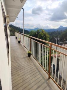 a balcony with a view of the mountains at Asprin Homestay in Munnar