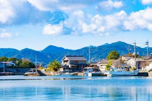 a marina with boats in the water and mountains at 青木邸 in Tokushima