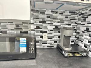 a kitchen with a microwave and a coffee maker at Spacious Entire Basement Suite with Free Parking Self Check In in Winnipeg +23 photos