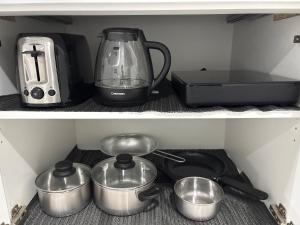 a kitchen with a blender and some pots and pans at Spacious Entire Basement Suite with Free Parking Self Check In in Winnipeg