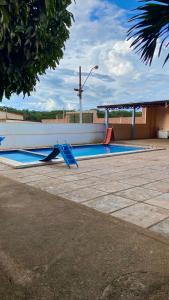 a swimming pool with a blue ramp in a parking lot at Sítio Relax in Tianguá