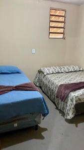 two beds sitting next to each other in a room at Sítio Relax in Tianguá