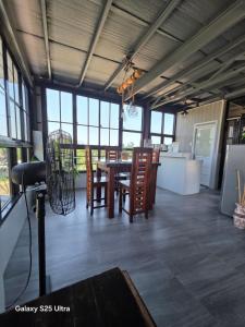 a dining room with a table and chairs and windows at ASHBURN'S TRANSIENT LA UNION - BAUANG, Self Service, Self Check-in, MOTORCYCLE Parking in Bauang