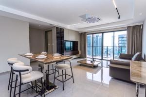 a living room with a table and a couch at Landison Hotel Penang in George Town