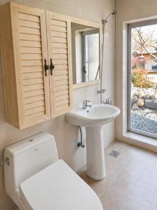 a bathroom with a toilet and a sink and a window at 스테이여온 in Miryang +37 photos