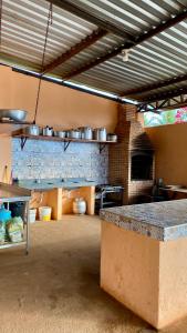 a large kitchen with pots and pans on the wall at Sítio Relax in Tianguá