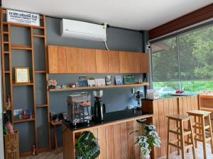 a kitchen with a counter with a coffee maker at Friendlyhostel in Khao Sok National Park