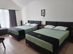 a bedroom with two beds and a couch at 24 Habitación doble cama in Miravalle