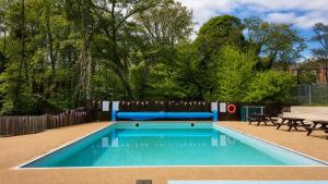 a swimming pool with a bench and a picnic table at 1 Bed in Winskill oc-c36298 in Little Salkeld