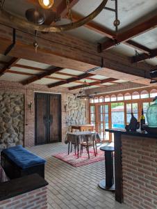 a living room with a table and a stone wall at Your home, Lagodekhi in Lagodekhi
