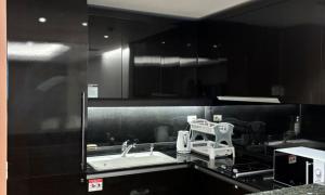 a kitchen with a sink and a counter top at Busan Centum Victoria hotel in Busan +70 photos