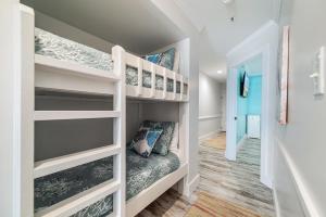 a childs room with bunk beds and a hallway at BeachFront, Bottom Level Condo at Tradewinds in Orange Beach