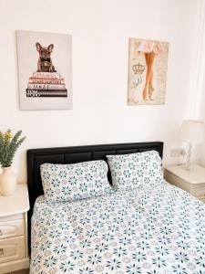 a bedroom with a bed with a blue and white comforter at Stylish Room in Wolverhampton opp Asda in Wolverhampton
