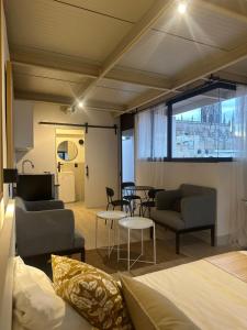 a room with a bed and chairs and a table at Casa Elisa - Expiatorio in Guadalajara