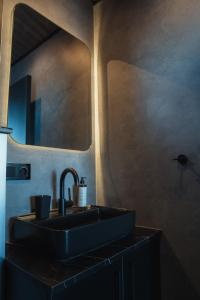 a bathroom with a black sink and a mirror at Tiny Glass lodge in Selfoss +42 photos