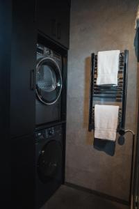 a laundry room with a washing machine and a drying rack at Tiny Glass lodge in Selfoss