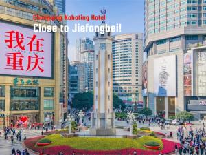 a group of people walking in a city with a monument at Kaboting Hotel Chongqing Prime Location Near Jiefangbei & Hongya Cave, 1 Minute Walk to Metro, Ideal for International Guests,Free Self-Service Laundry, Free High-Speed WiFi,Free Chinese Tea, Free Travel Advice in Chongqing +14 photos