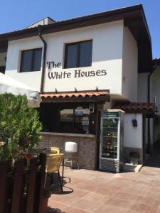 a white house with a sign that reads the white house at The White Houses Complex in Nesebar