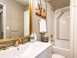 a white bathroom with a sink and a tub at Elevate Your Stay Chic 1-Bed Condo Courtyard in Dallas +30 photos