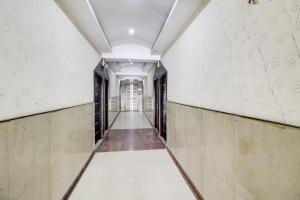 an empty corridor of an office building with a hallway at Hotel O Mukut Mahal in Meerut
