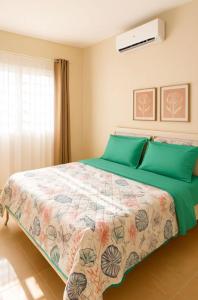 a bedroom with a large bed with green pillows at Luxury Comfort Villa in Punta Cana