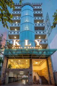 a tall blue building with a k hotel sign on it at KLY Hotel & Retreat in Vung Tau