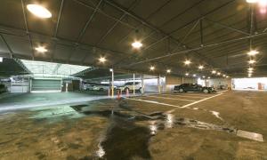 an empty parking lot with cars parked in a garage at Daegu Seongseo Hotel Series 5.0 in Daegu