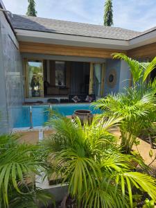 a house with a swimming pool in a yard at Golden Villa in Ko Phangan