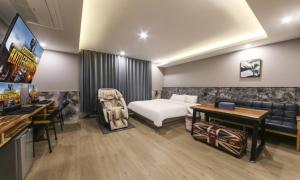 a hotel room with a bed and a couch at Daegu Seongseo Hotel Series 5.0 in Daegu +64 photos