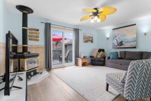 a living room with a couch and a fireplace at "At the Eau" - Charming 2 Bedroom Cottage! in Erieau