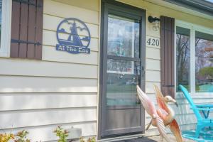 a front door of a restaurant with a bird statue outside at "At the Eau" - Charming 2 Bedroom Cottage! in Erieau