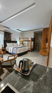 a hotel room with a tea kettle on a tray at Wana Kubu Suite and Dormitory in Ngurah Rai International Airport +58 photos