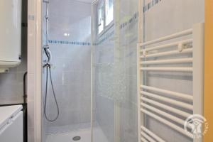 a shower with a glass door in a bathroom at Les papillons in Plérin +22 photos