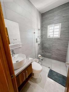 a bathroom with a sink and a toilet and a shower at Luxury Comfort Villa in Punta Cana +8 photos