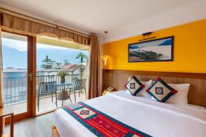 a hotel room with a bed and a balcony at Sapa Panorama Hotel in Sapa +113 photos