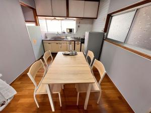 a dining room with a table and chairs in a kitchen at 城下の宿庵 in Ōzu