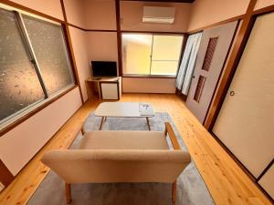 a living room with a couch and a table at 城下の宿庵 in Ōzu