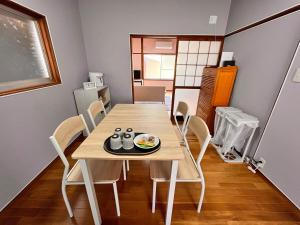 a dining room with a table and chairs in a room at 城下の宿庵 in Ōzu +5 photos