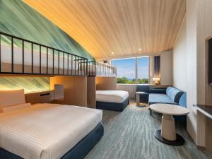 a hotel room with two beds and a couch at Kiyosato Kogen Resort in Hokuto